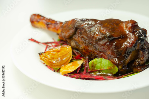 Delicious Lamb shank with red wine and rosemary gravy served on the mixed leaf salad