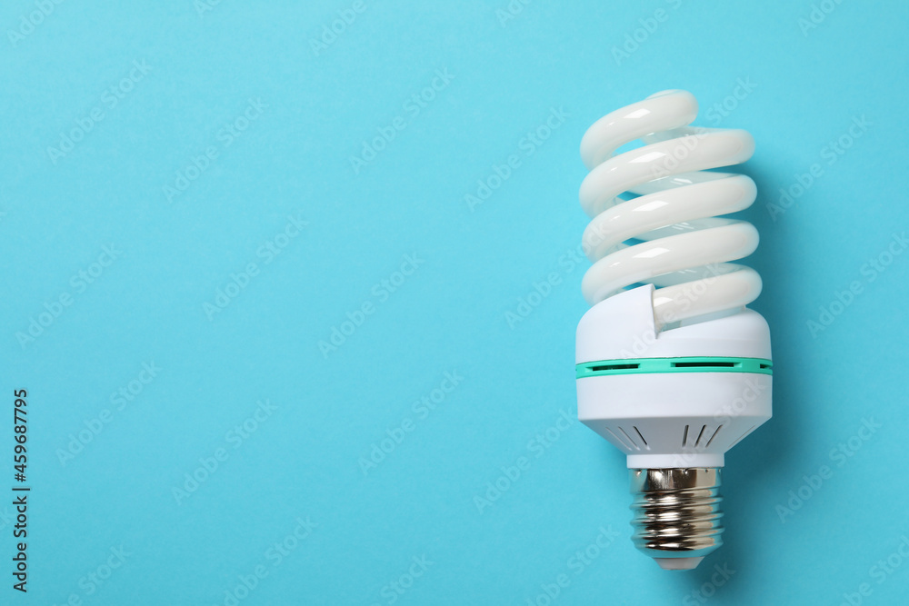 Energy saving bulb on blue background, space for text Energy saving bulb on blue background, space for text