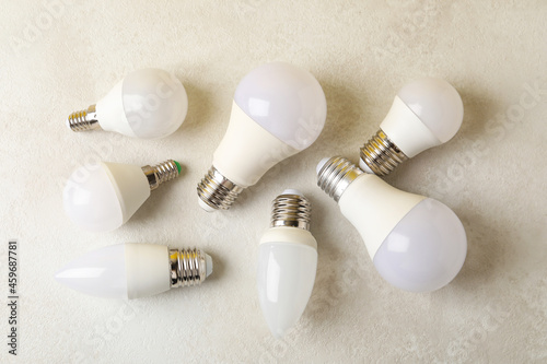 Energy saving bulbs on white textured background