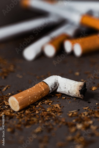 A pack of cigarettes and a bunch of cigarette butts