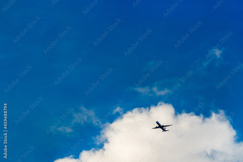 Silhouette of an airplane taking off against a background