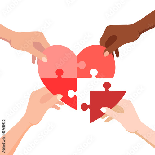 Hands connecting jigsaw puzzle in heart form. Concept of love, volunteering, charity and donation