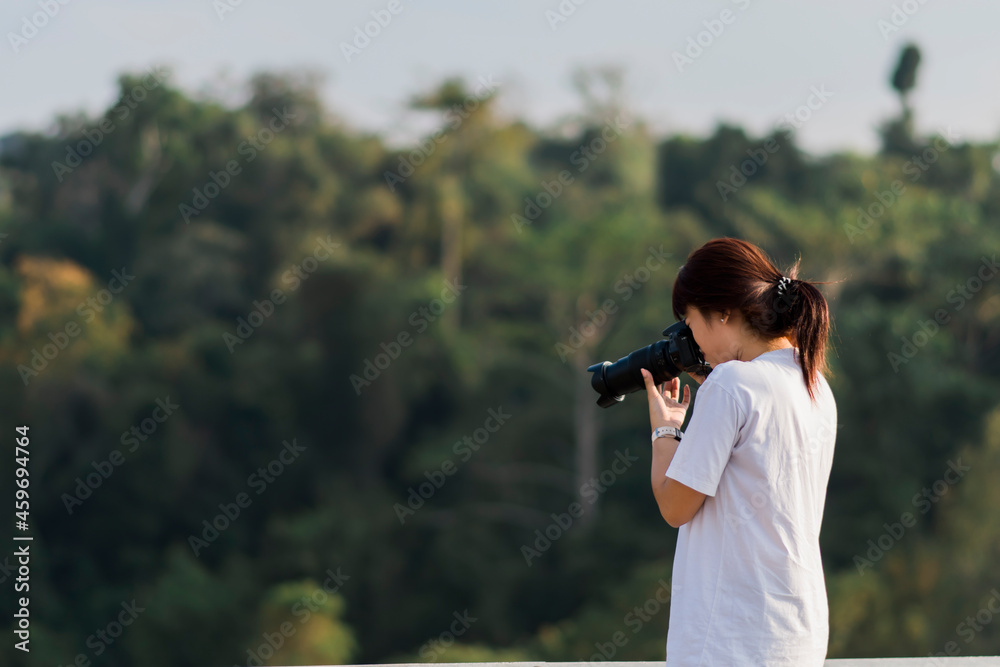 Female photographer taking pictures with natural background Female photographer taking pictures with natural background