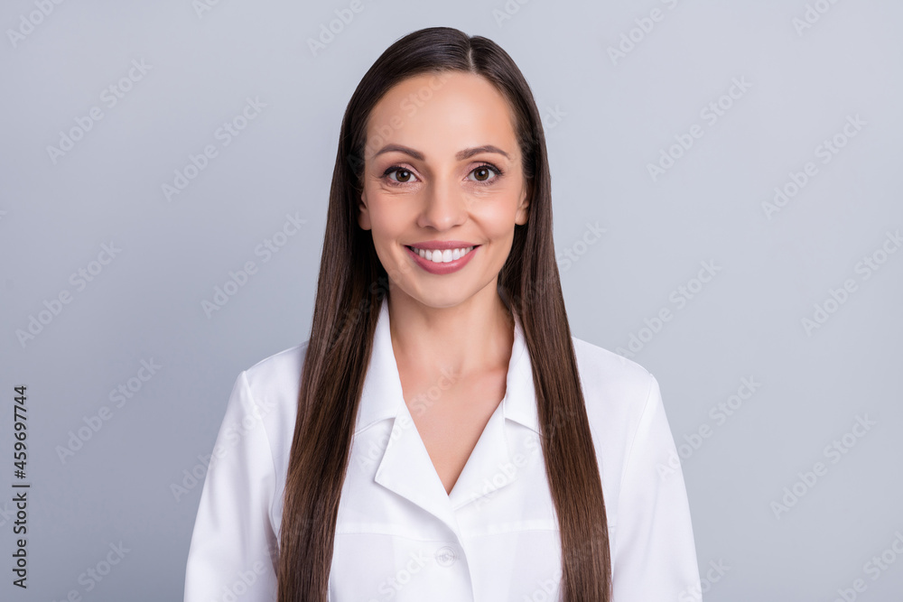Photo of confident charming lady doctor wear white formal coat smiling isolated grey color background Photo of confident charming lady doctor wear white formal coat smiling isolated grey color background