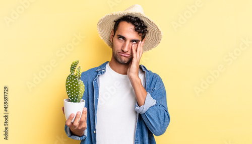 Принти на полотні hispanic handsome man feeling bored, frustrated and sleepy after a tiresome farm