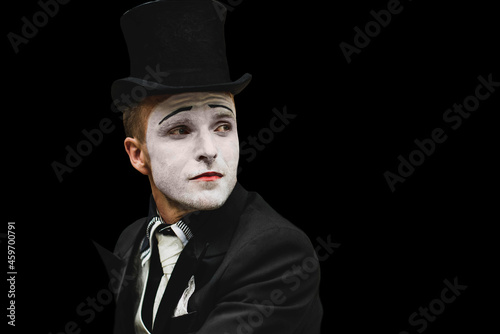 portrait of elegant expressive male mime artist posing on black background. Close-up portrait of a male mime artist. Halloween costume.