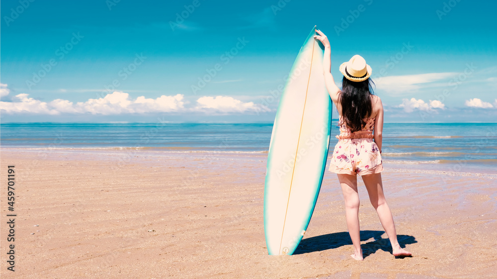  Surfer girl on the beach holding surf board watching ocean in sunny day. True happy emotions of young active pretty woman prepare to surfing. Summer vacation lifestyle. outdoor.