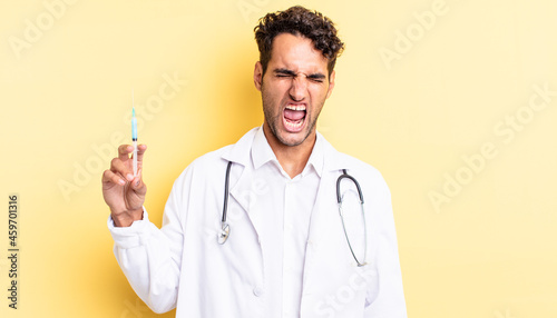 hispanic handsome man shouting aggressively, looking very angry physician and srynge concept photo
