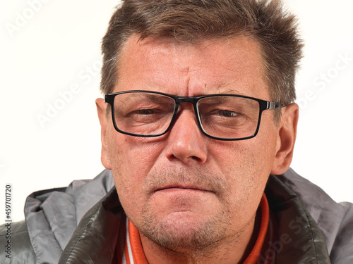 old not shaved man in glasses with facial expressions close-up