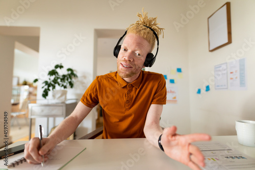 Albino african american man working from home making video call photo