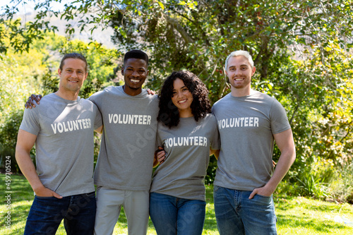 Quadro em tela Group of smiling deverse female and male volunteers in matching tshirts looking