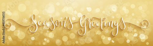 SEASON'S GREETINGS white vector brush calligraphy banner with snowflakes on gold background with bokeh lights