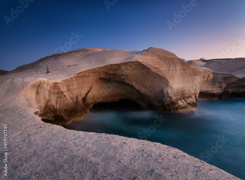 Fototapeta Naklejka Na Ścianę i Meble -  Sarakiniko beach. Milos island. Greece. A seascape during sunset. Long exposure. Rocks on the seashore.