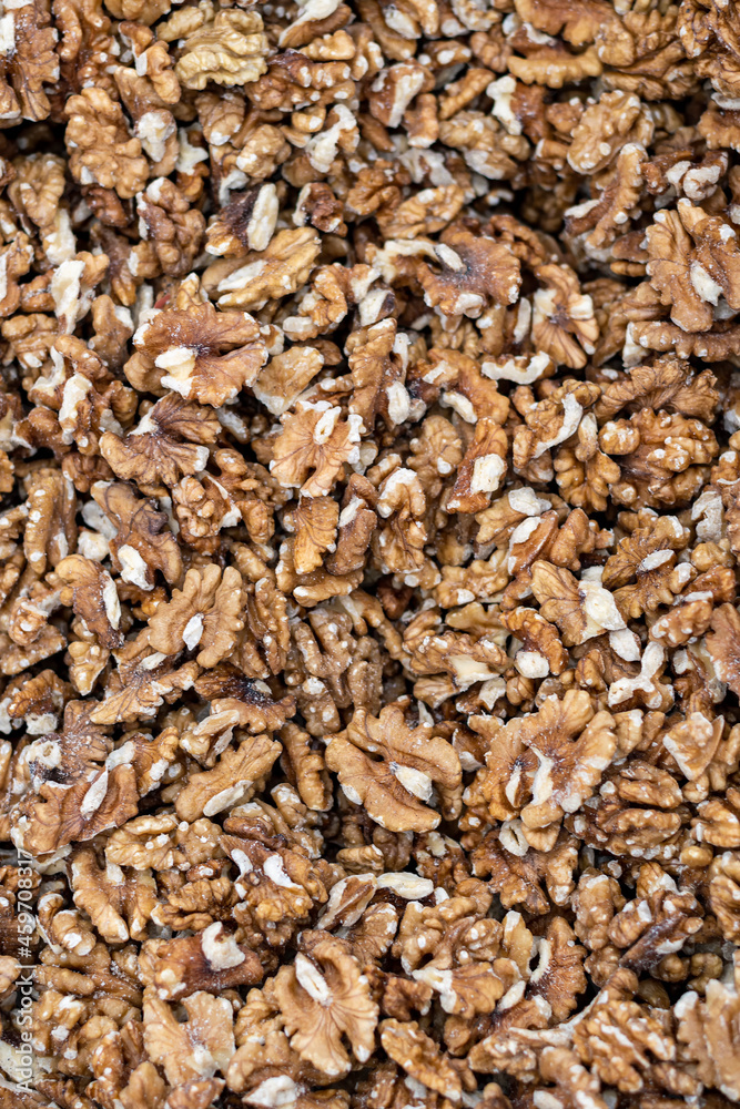 Peeled walnut kernels sit on the store counter and create an abstract texture.