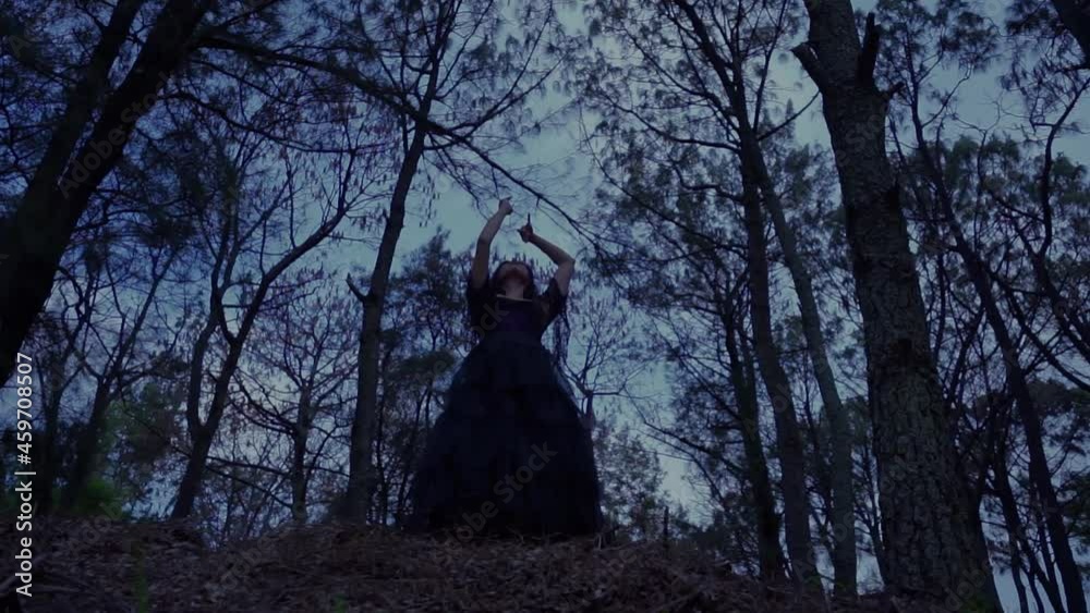 Enchantress dancing in dark woods