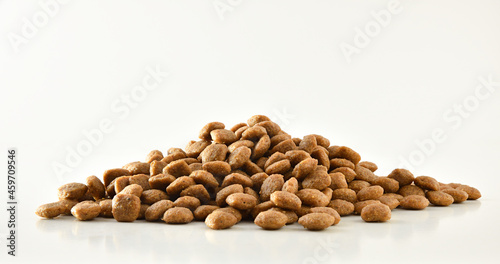 Pile of dry food kibbles for pets on white front