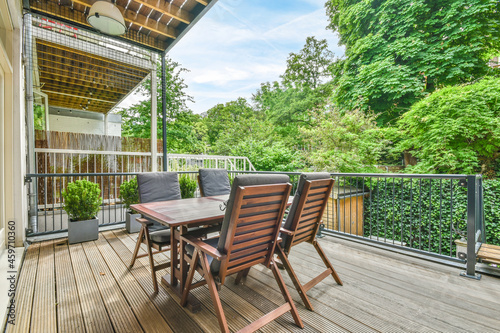 Table and armchairs on wooden terrace