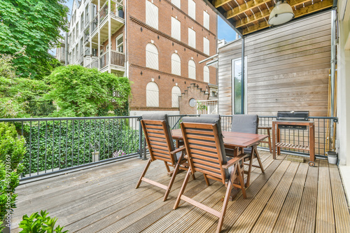 Table and armchairs on wooden terrace photo