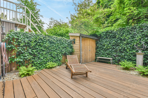 Wooden lounger on terrace of house photo