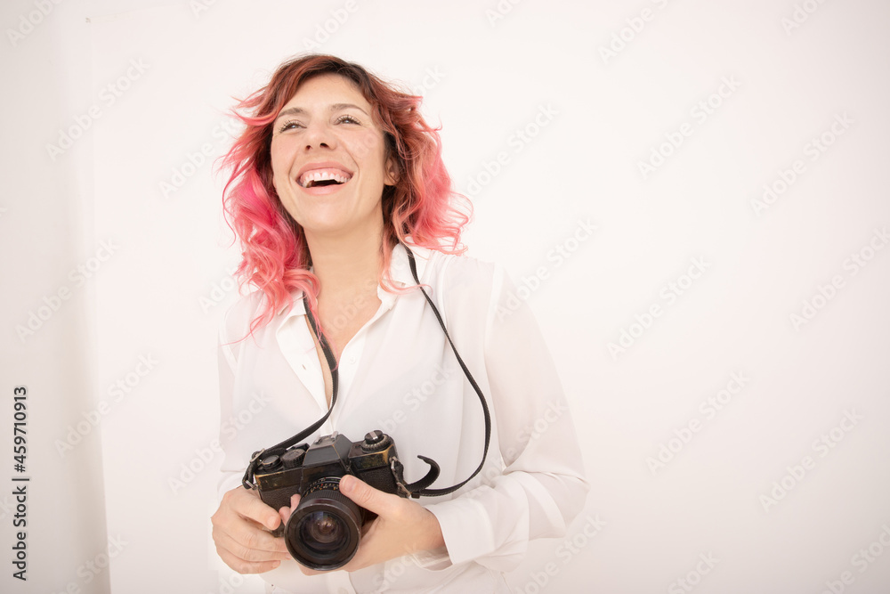 Happy woman with a camera in her hands on a light background Happy woman with a camera in her hands on a light background