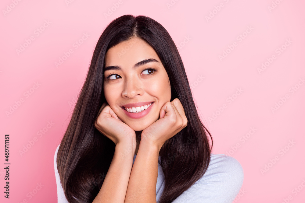 Photo portrait of girl with brunette hair smiling happy looking empty space isolated on pastel pink color background Photo portrait of girl with brunette hair smiling happy looking empty space isolated on pastel pink color background