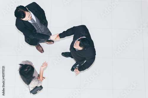 Business team shaking hands during meeting at office. Top view.