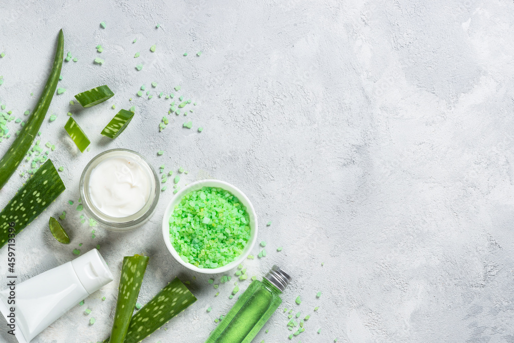 Aloe vera cosmetic. Face cream, tonic and sea salt with natural aloe extract at stone background. Top view with copy space. Aloe vera cosmetic. Face cream, tonic and sea salt with natural aloe extract at stone background. Top view with copy space.