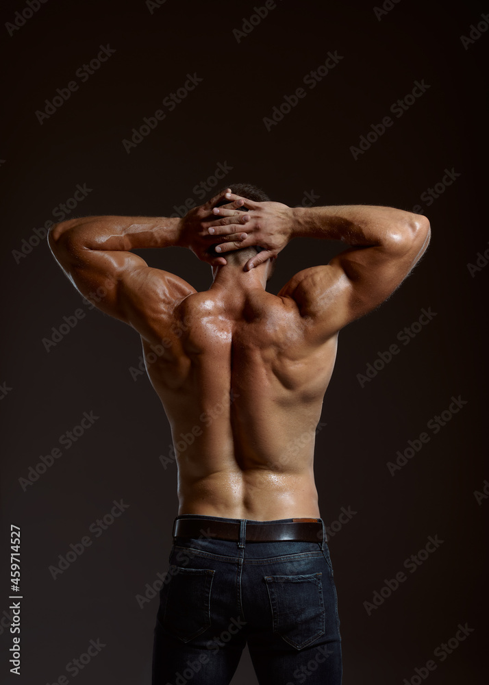 Male athlete with muscular body, back view