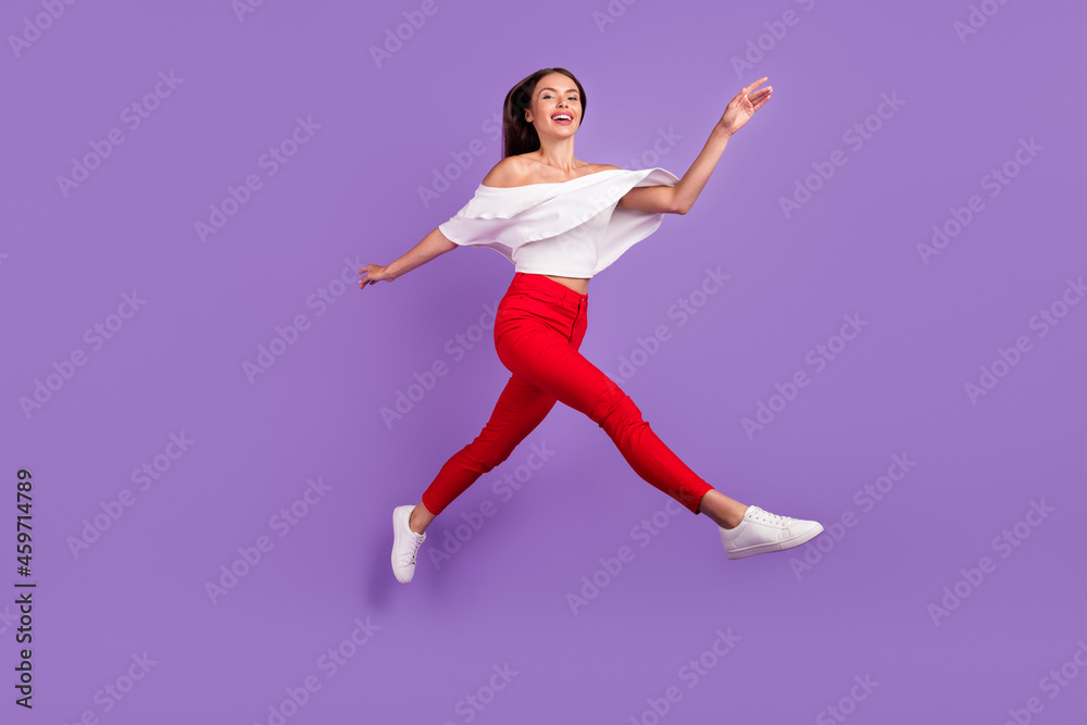 Photo of glad dreamy sporty lady jump run enjoy flight wear white blouse isolated purple color background