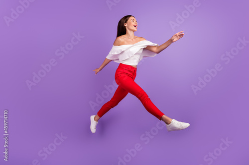 Profile photo of excited lady jump run look empty space wear white blouse trousers shoes isolated purple color background