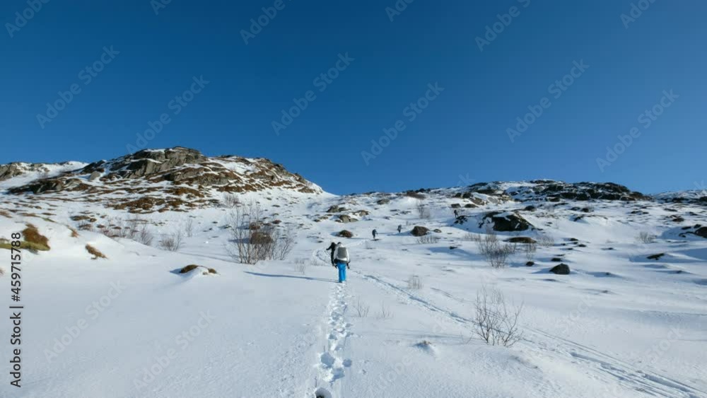 Mountaineer group hiking on snowy mountain with blue sky at norway Mountaineer group hiking on snowy mountain with blue sky at norway