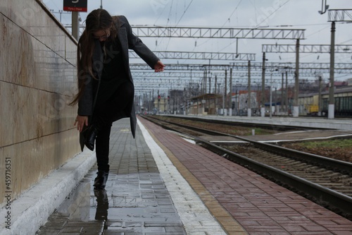 woman walking on railway