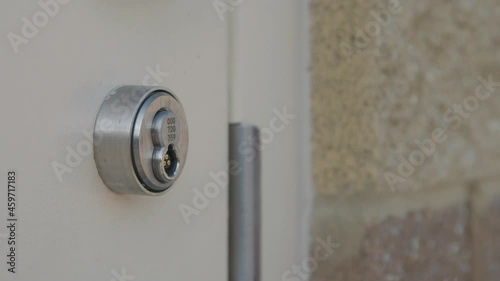 Person unlocks commercial door with electronic key fob, high security at work