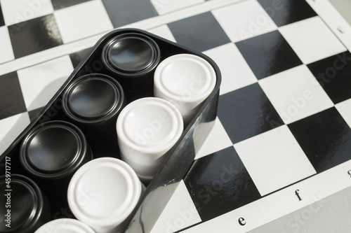 Chess board with checkers. Hobby. checkers on the playing field. Board games. Black and white checkers.