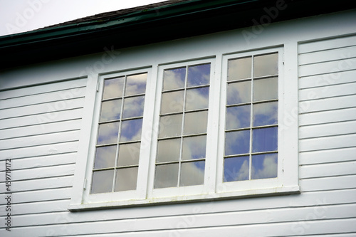 Window in a house with cumulus clouds.