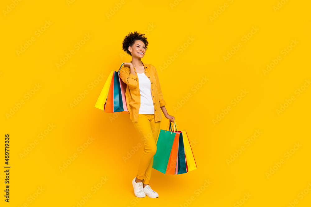 Full body profile side photo of young black girl customer buy shop sale bag isolated over yellow color background