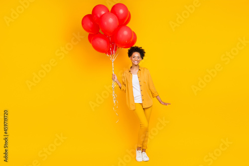 Full length body size photo woman keep fancy air balloons at party isolated vivid yellow color background