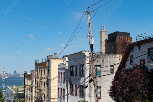 Row of Residential Buildings and Telephone Lines on a Hill in St. George of Staten Island in New York City