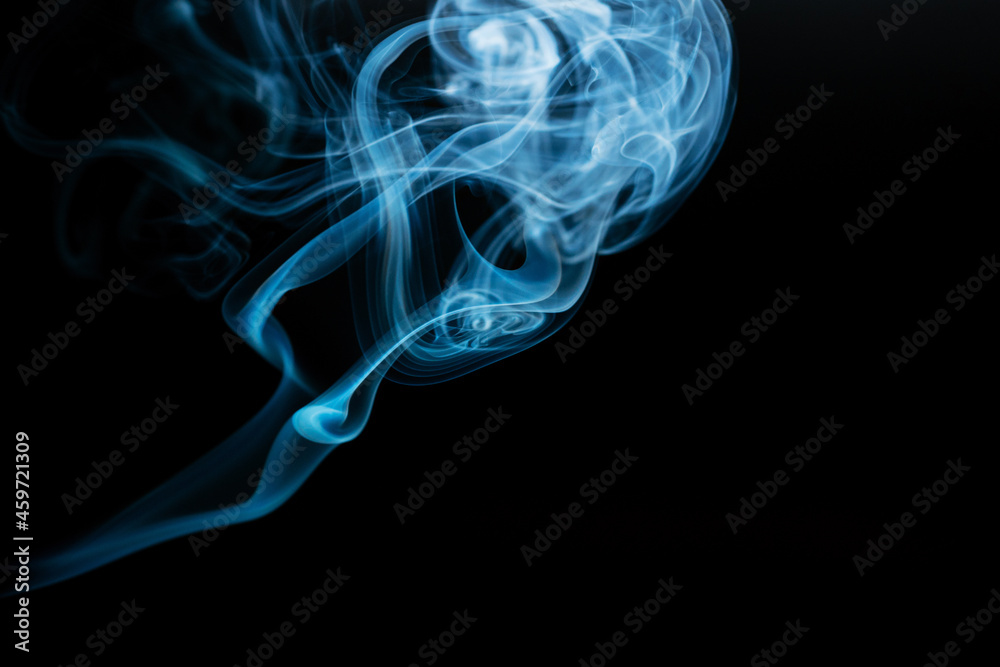 Abstract colored smoke moves on dark background. Wallpaper. Personal vaporizers fragrant steam. Concept of alternative non-nicotine smoking. E-cigarette. Texture. Design elements.