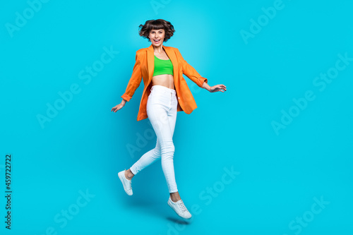 Fototapeta Naklejka Na Ścianę i Meble -  Full size photo of happy positive woman jump up good mood vacation enjoy isolated on blue color background