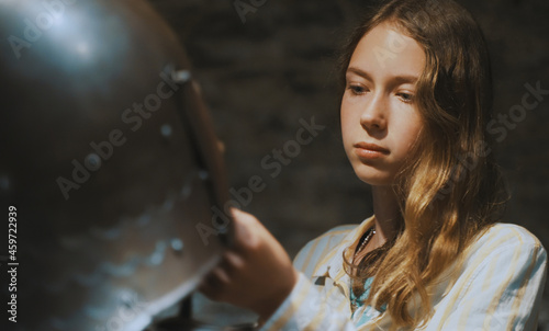 Schoolgirl examines the armor in the museum.