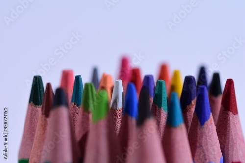 Multi-colored pencils sharpened on a white background, depth of field. Background. White.
