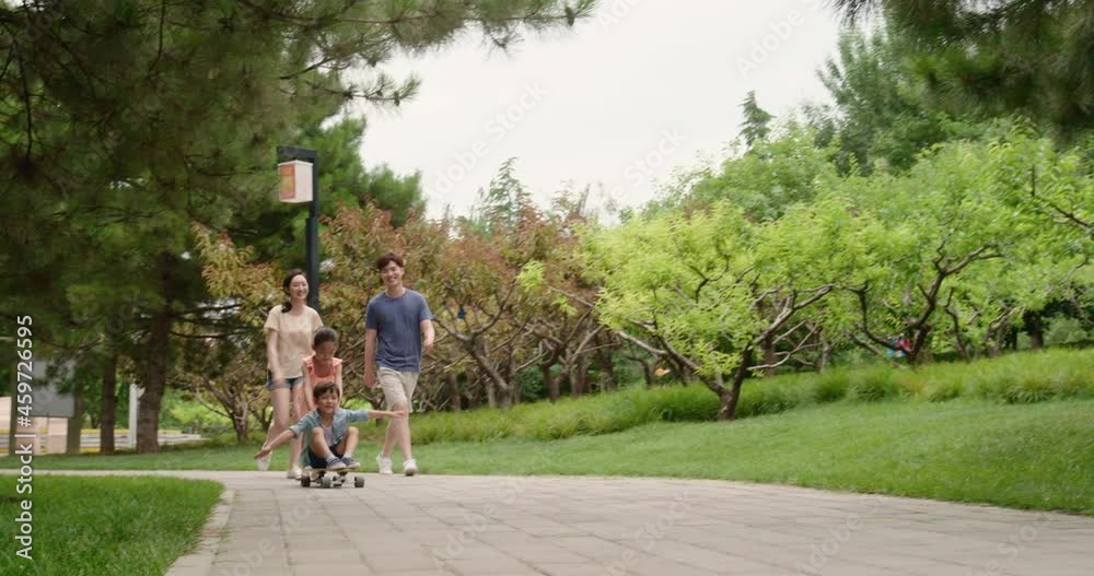 Happy young family playing in park,4K Happy young family playing in park,4K