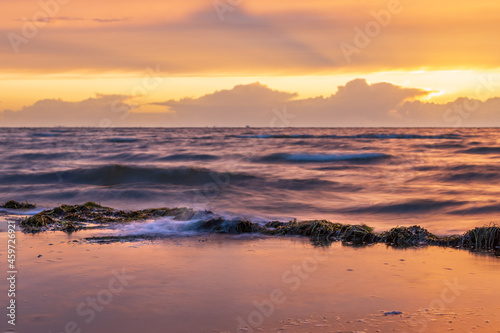 Fototapeta Naklejka Na Ścianę i Meble -  Shot of the Baltic sea waves during sunset in Lubmin, Mecklenburg-Vorpommern, Germany