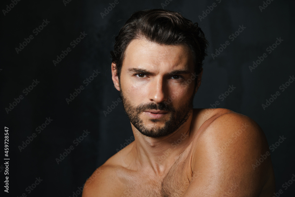 Young half-naked man posing and looking at camera