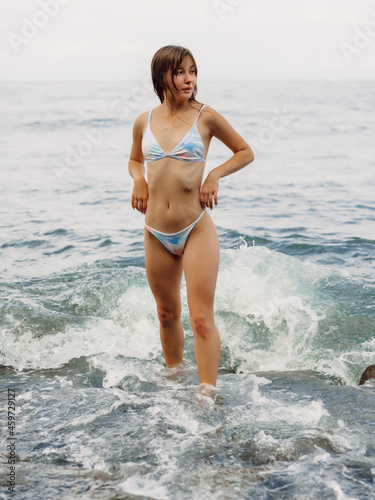 Attractive woman posing at ocean coastline. Caucasian model © artifirsov