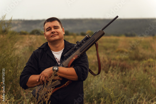 European shoots a rifle with a optics sight. Portrait of a shooter with a rifle