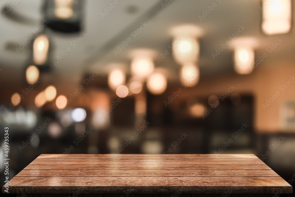 Empty surface wood top table with blur restaurant coffee shop background.