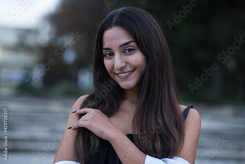 Portrait of a beautiful, happy and attractive Caucasian or Arabian brunette girl dressed in casual style. © Павел Костенко