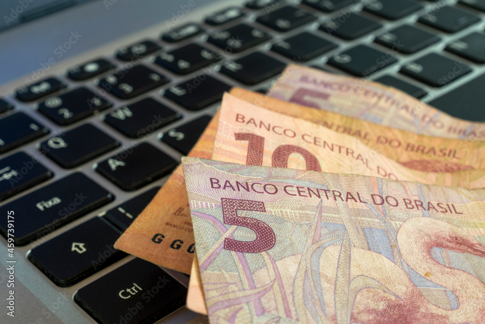 brazilian money on computer keyboard. 5 reais brazilian money on computer keyboard. 5 reais